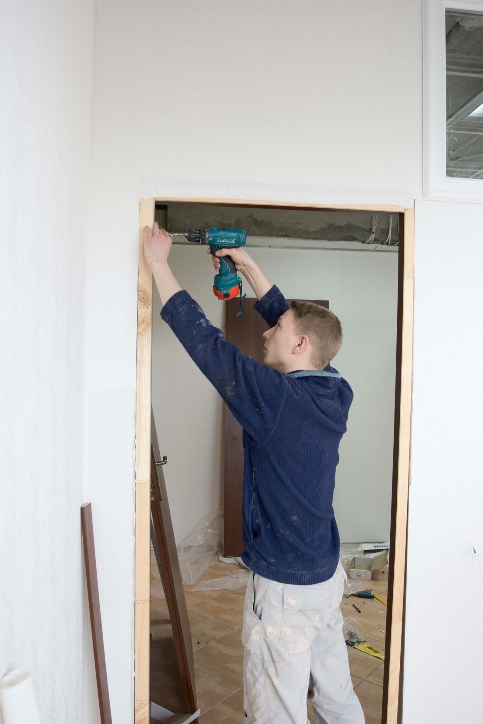Local Carpenter Installing A Door Jamb