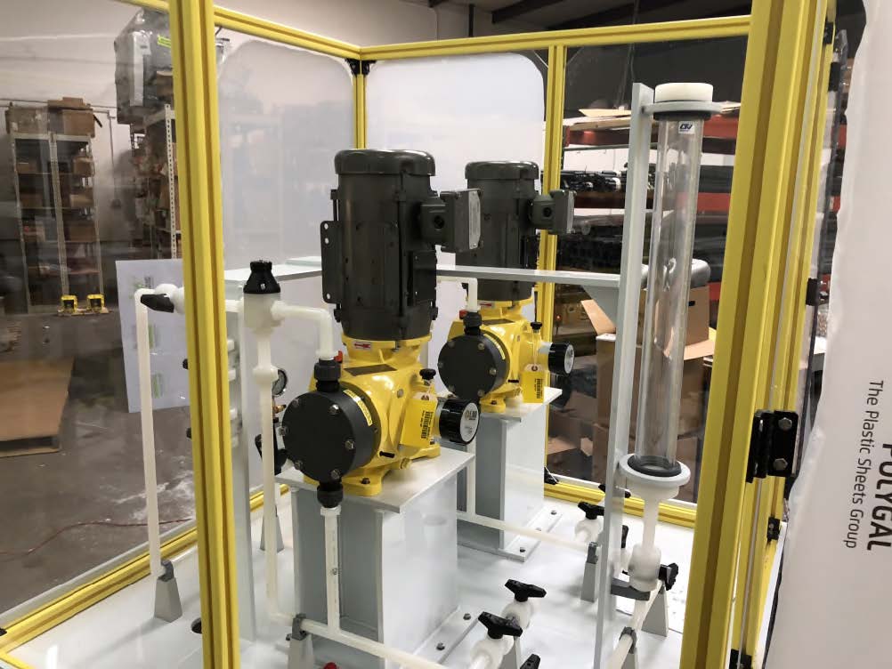 A row of yellow pumps are sitting inside of a yellow cage.