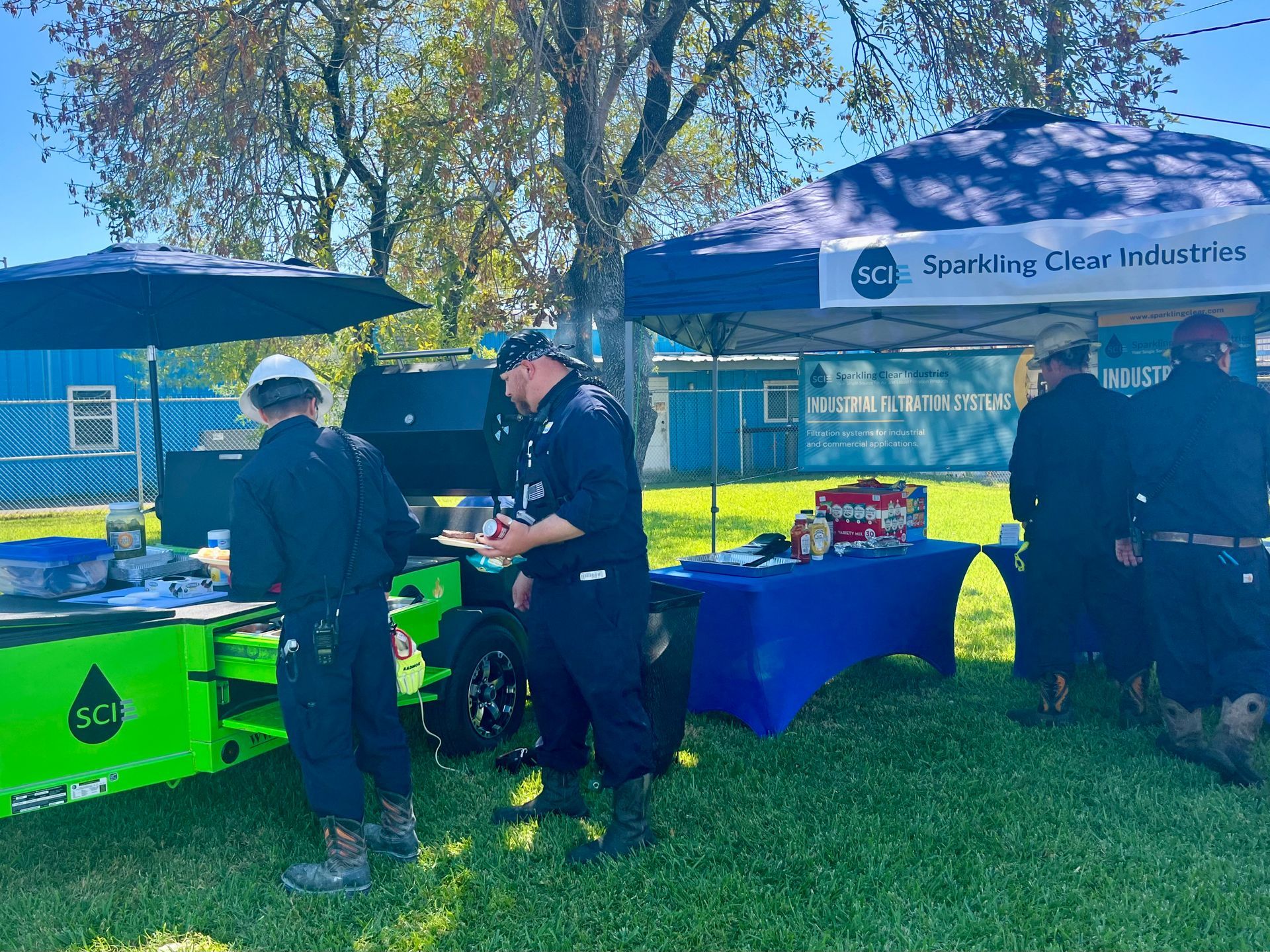 Sparkling Clear Industries serving burgers out of our Green Monster Cook Trailer on a Sunny Friday