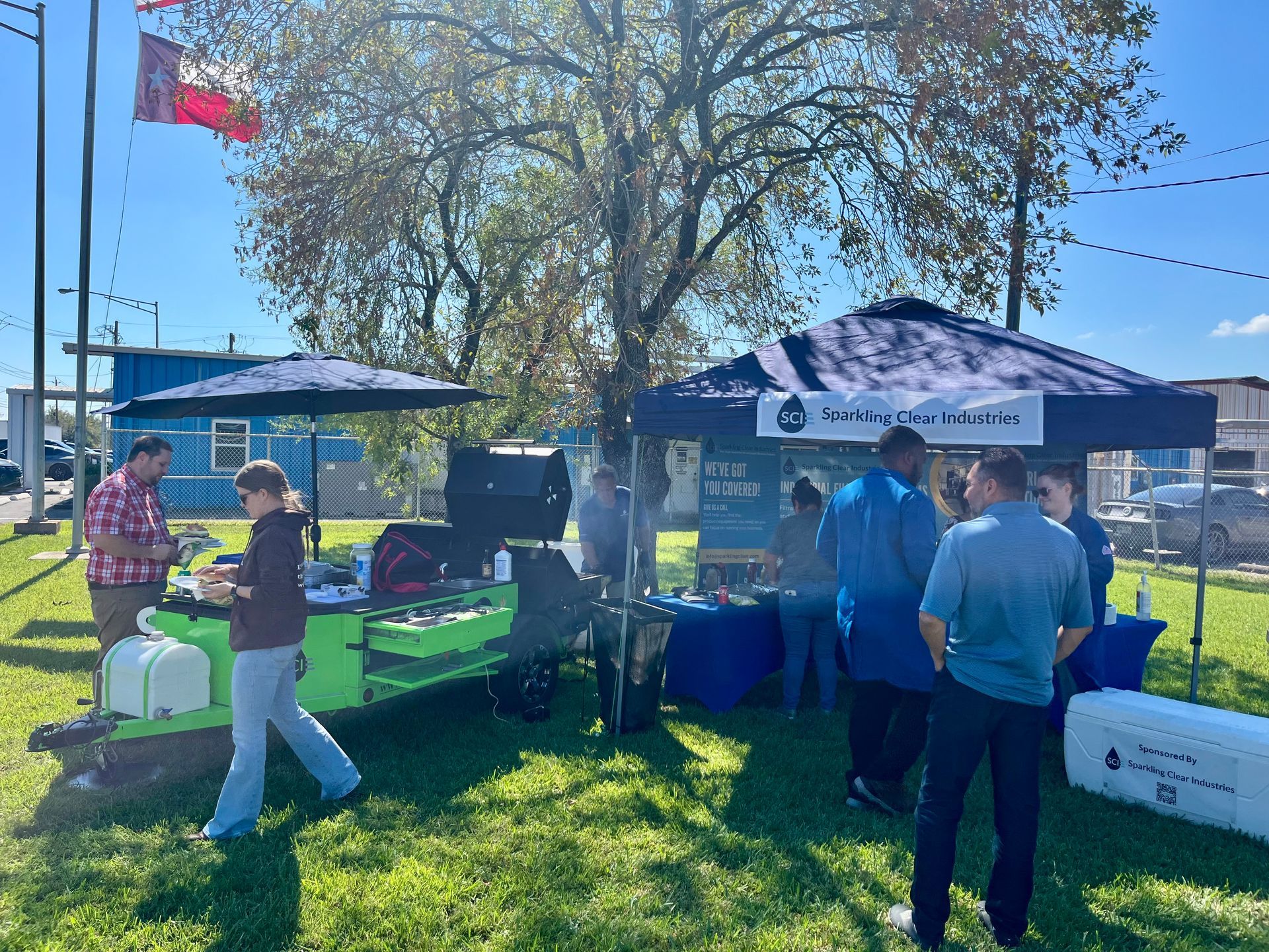Sparkling Clear Industries serving burgers out of our Green Monster Cook Trailer on a Sunny Friday afternoon