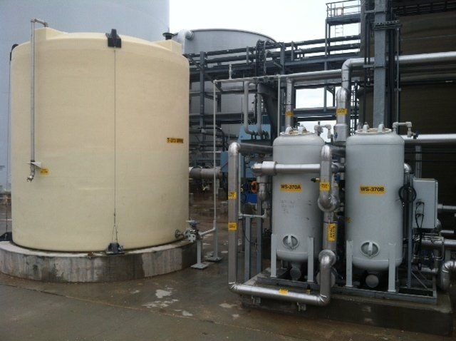 A large white tank sits next to two smaller tanks