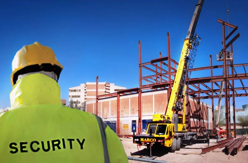 A security guard is looking at a construction site