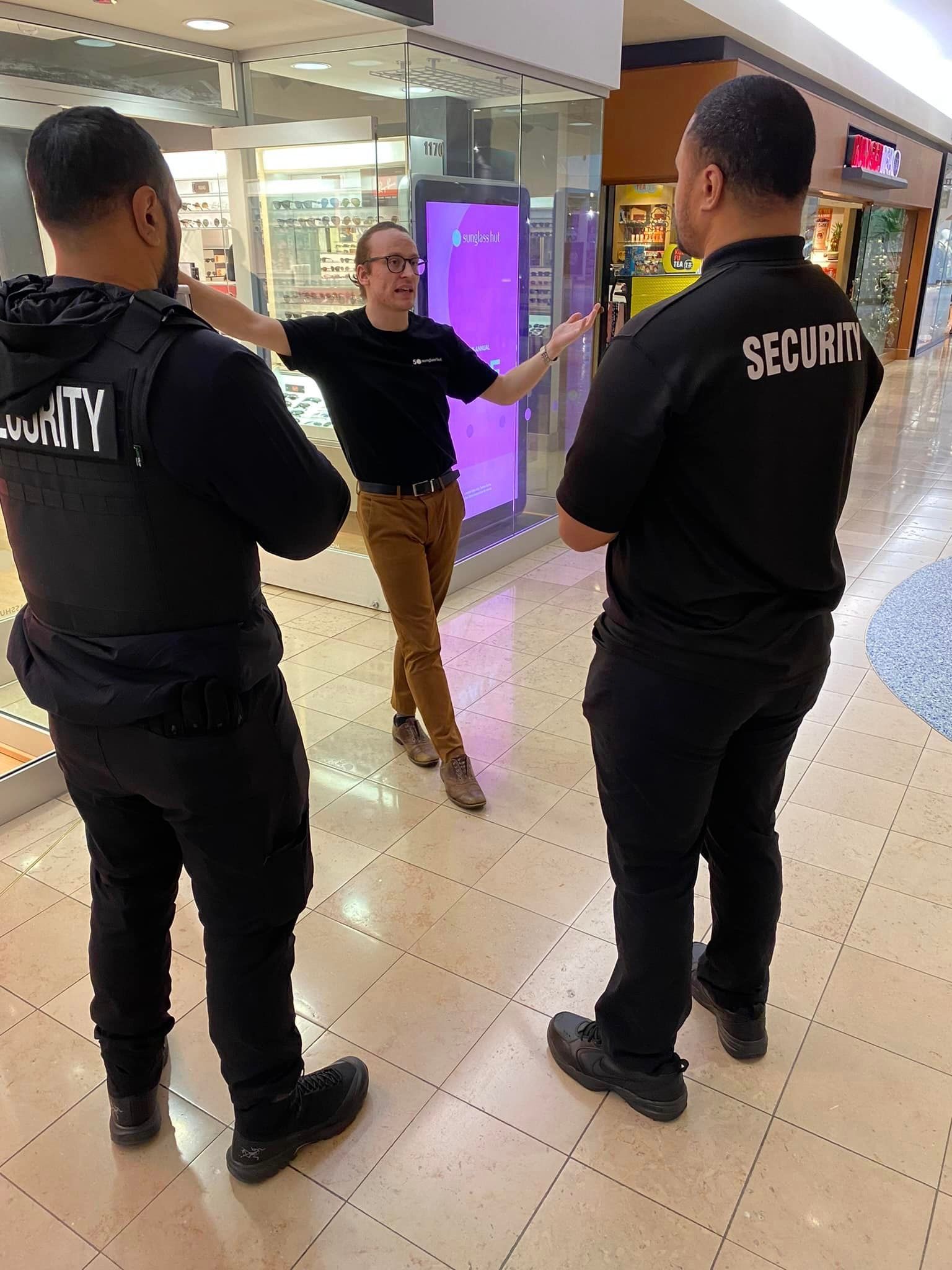 A man in a black shirt with the word security on it