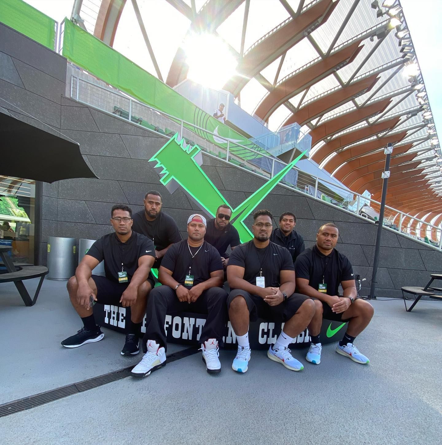A group of men are posing for a picture with a sign that says the pont
