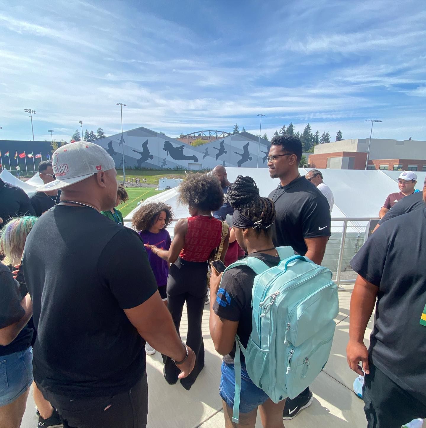 A group of people standing in front of a skate park
