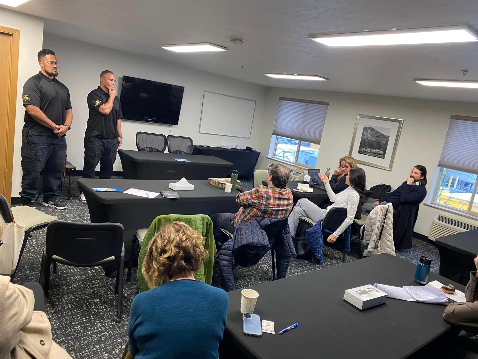 A group of people are sitting at tables in a room.