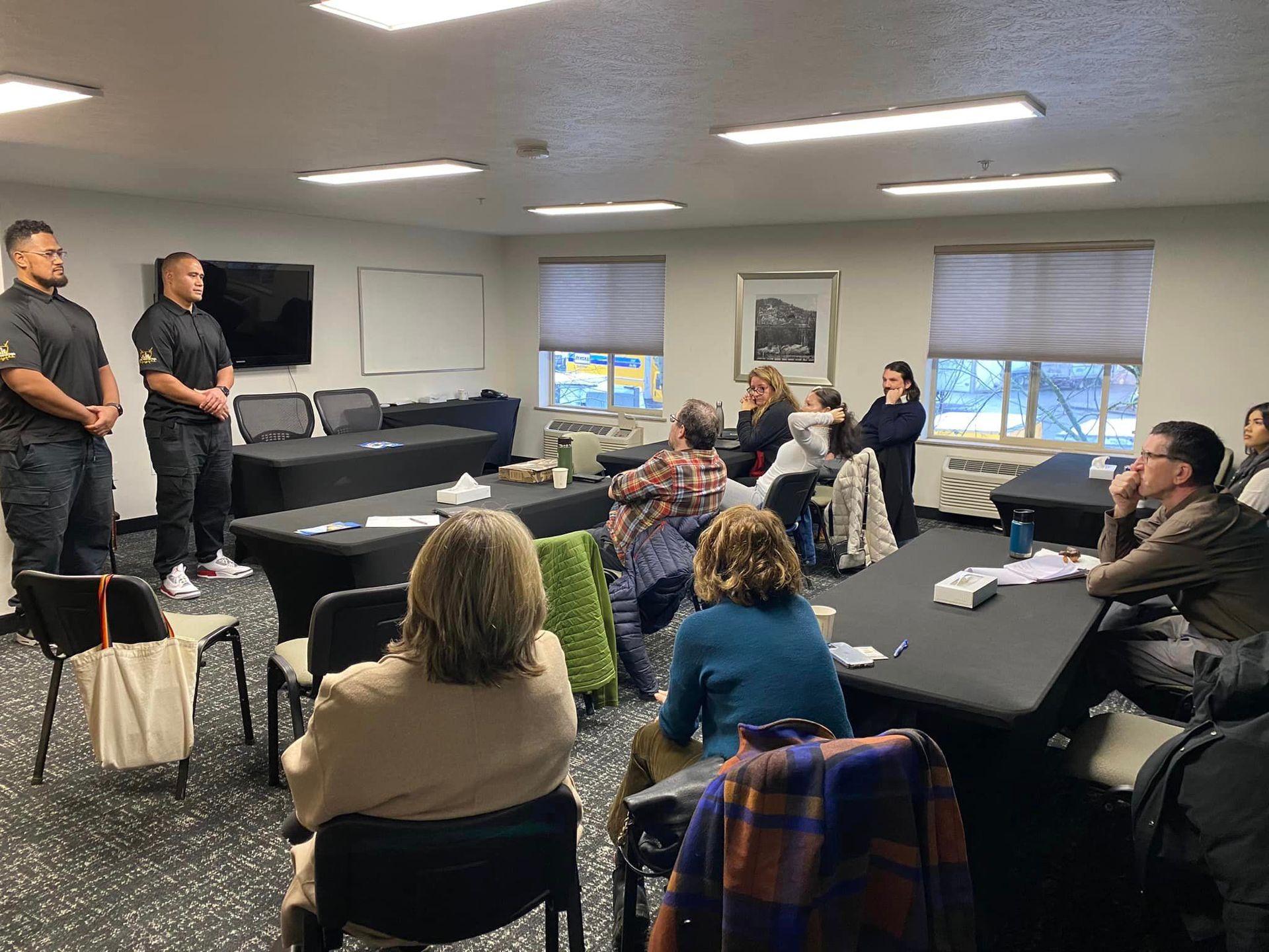 A group of people are sitting at tables in a room.
