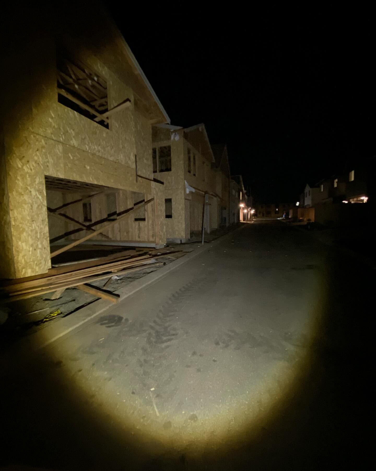 A house is being built at night in a residential area.
