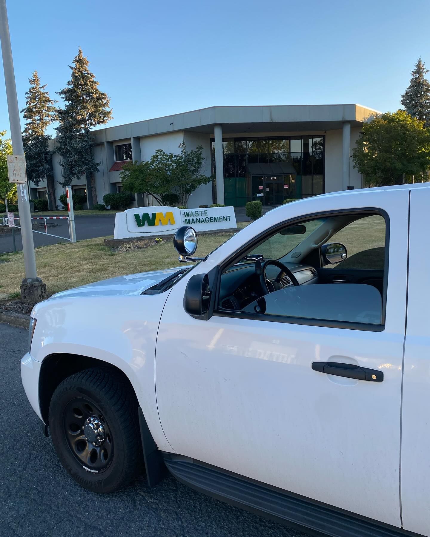 A white truck is parked in front of a building.
