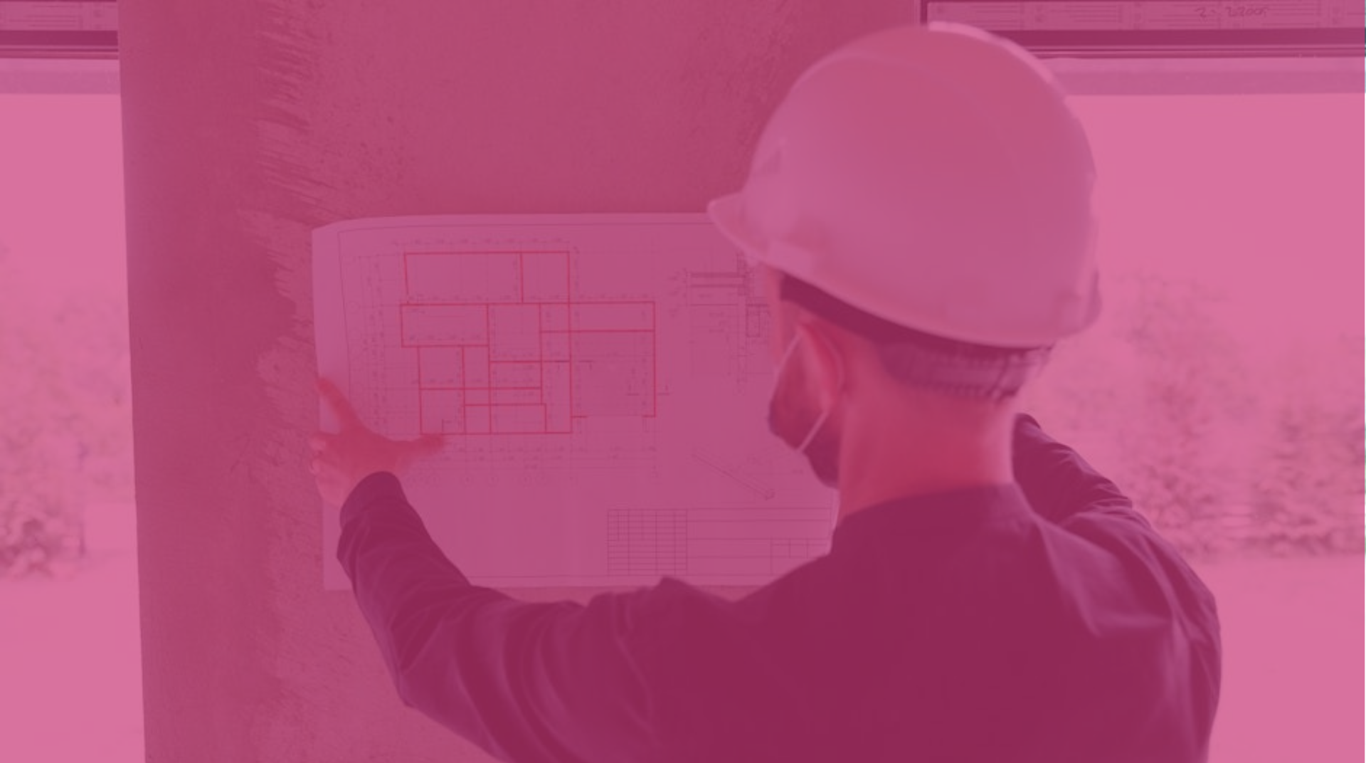 Contractor checking a floor plan at a construction site.