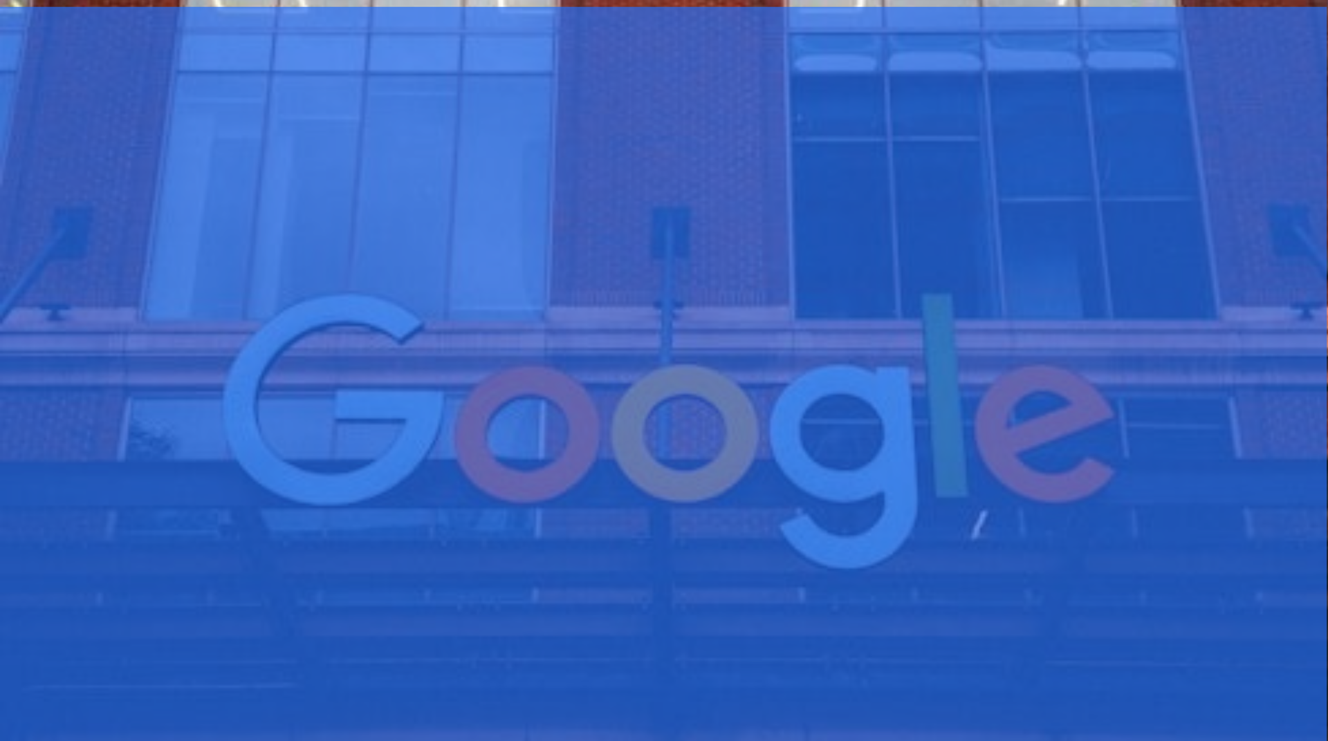 Google logo on a blue-tinted glass building facade