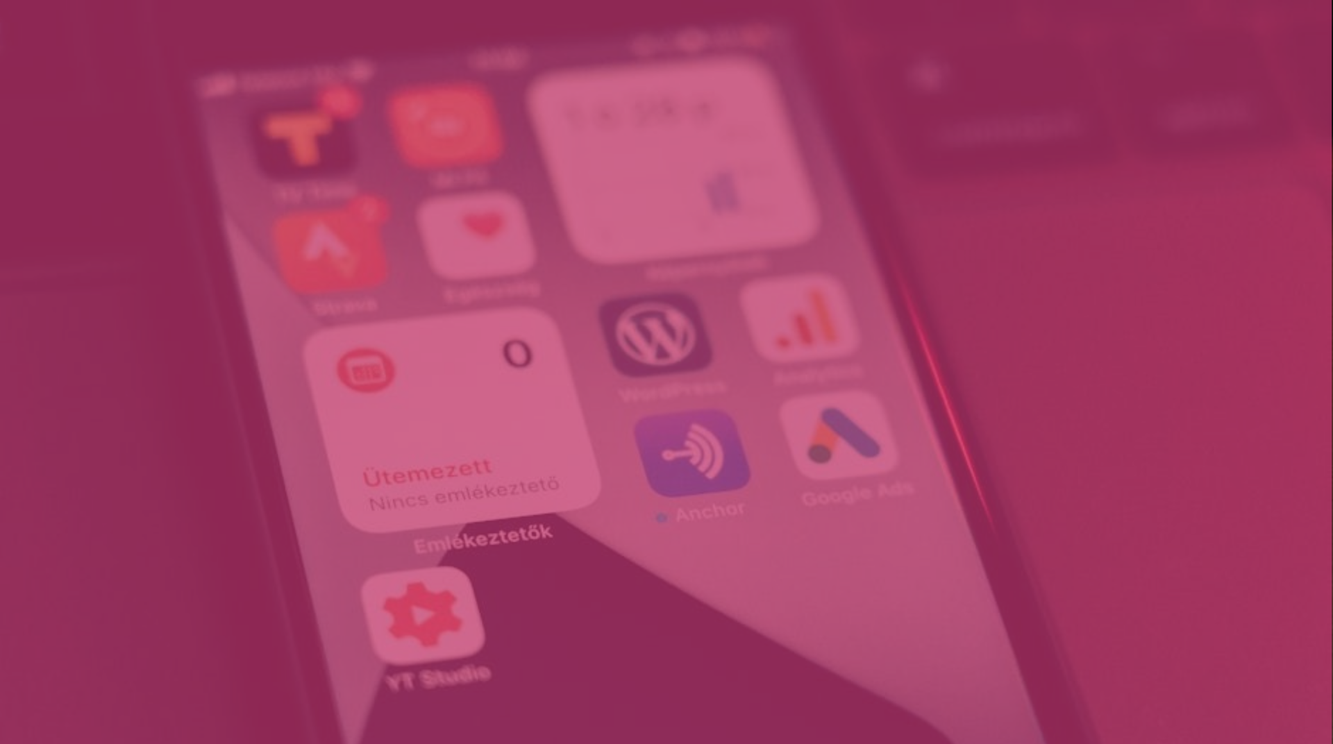 Pink-tinted smartphone home screen with app icons visible under a blurred overlay