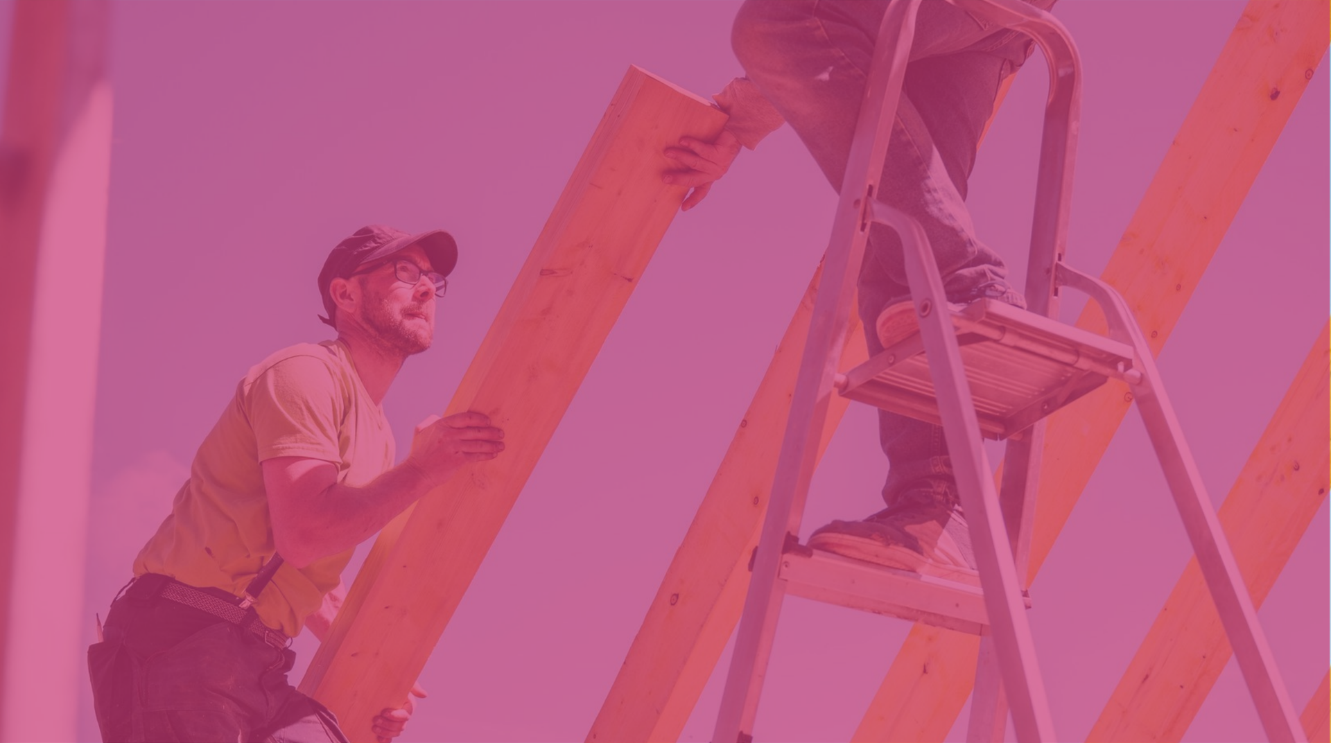 Construction workers handling wooden planks on site
