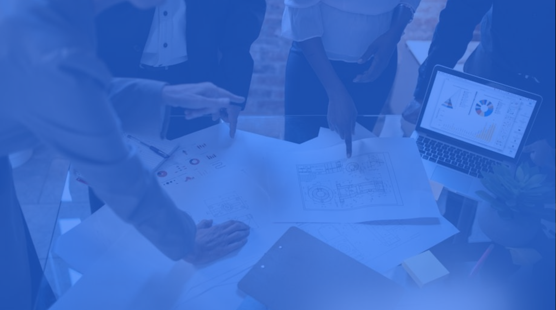 Team of civil engineers looking over building plans.