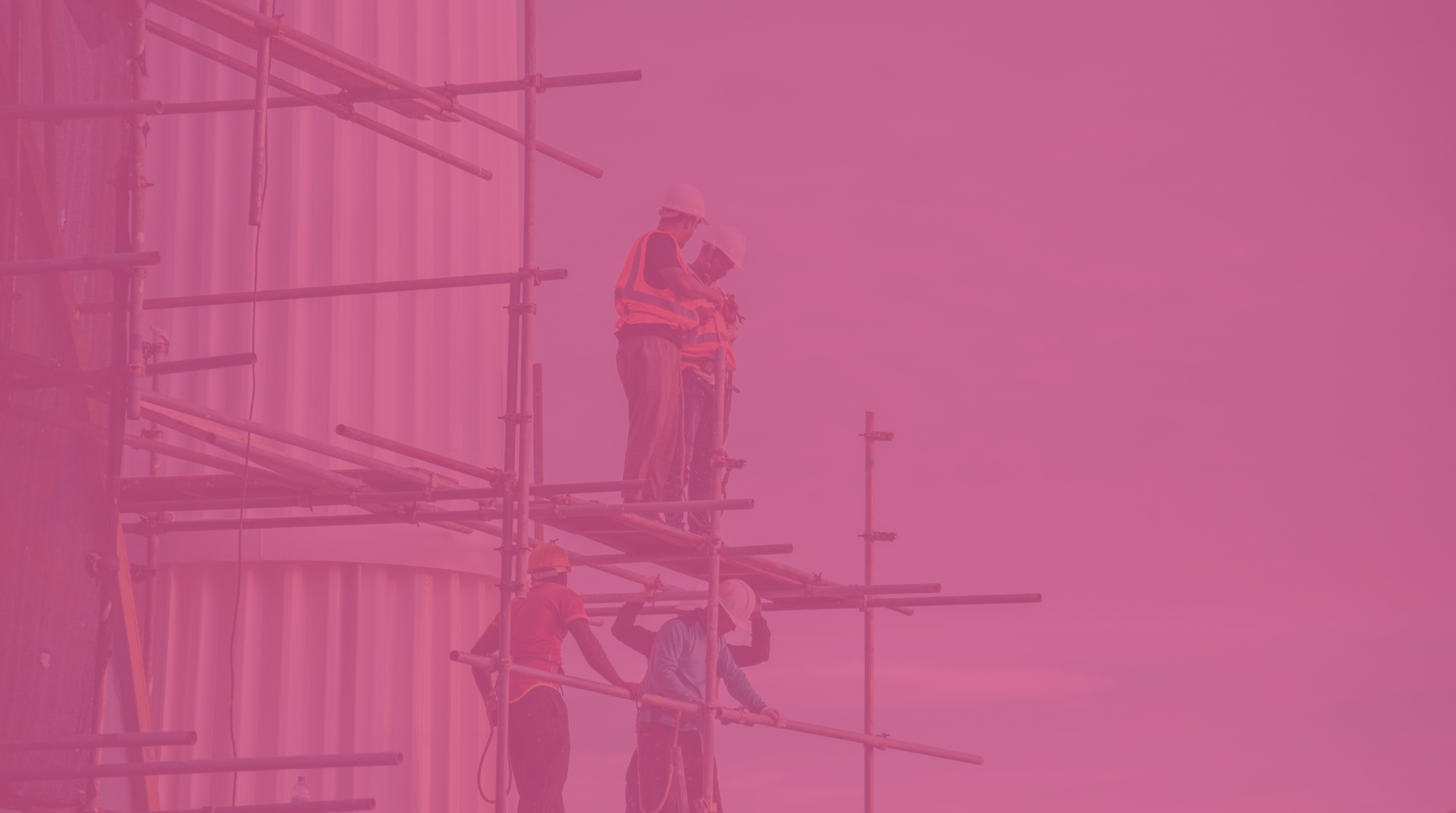 Construction workers standing on scaffolding