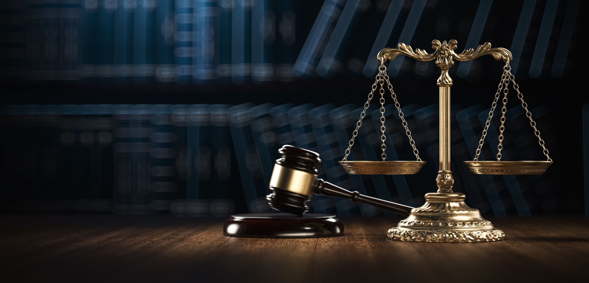 A judge 's gavel and scales of justice are on a wooden table.