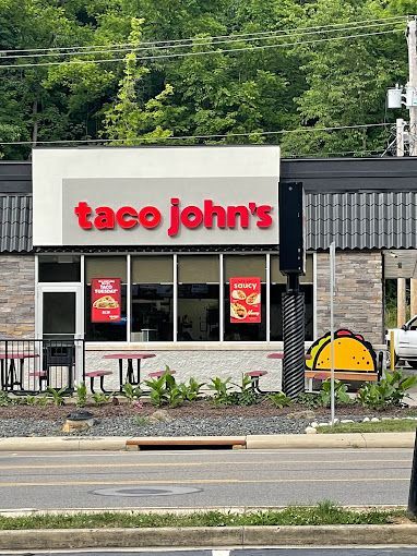 A taco john 's restaurant is located on the side of the road.