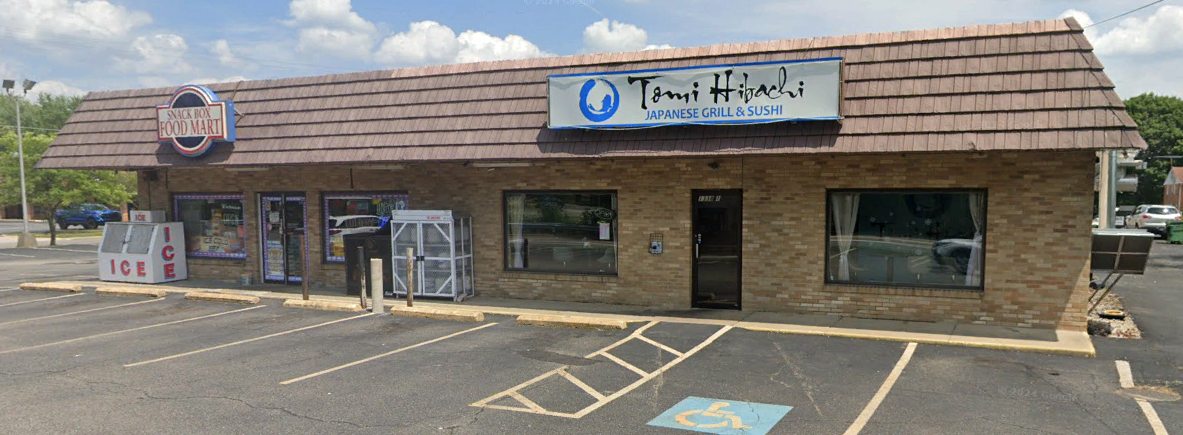 A brick building with a handicapped parking space in front of it.