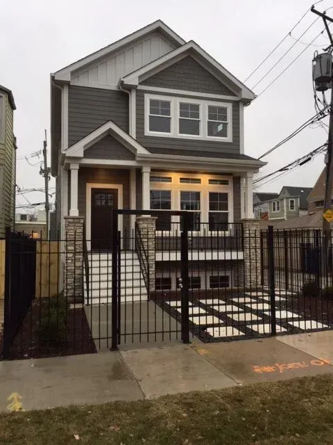 The front of a house with a fence around it