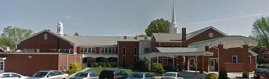 A large brick building with cars parked in front of it