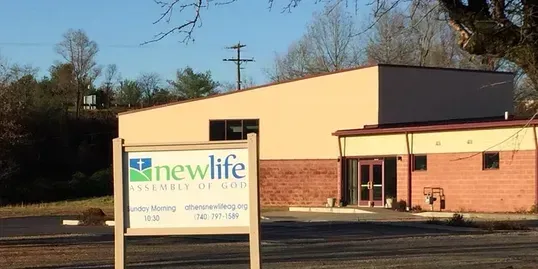 A building with a sign in front of it that says newlife.