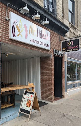 A brick building with a sign that says `` mr. hibachi japanese grill & sushi ''.