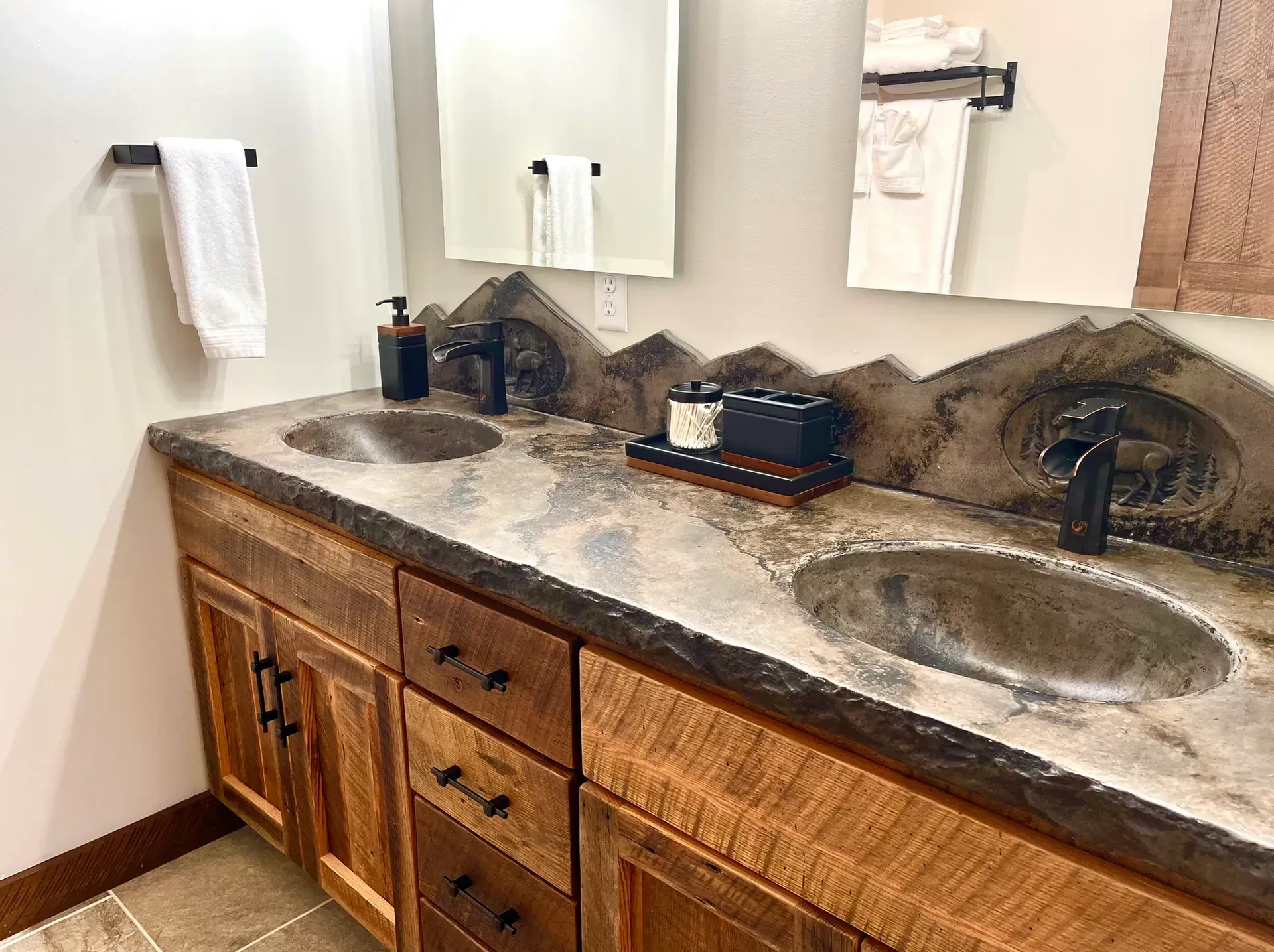 A bathroom with two sinks and a mirror.