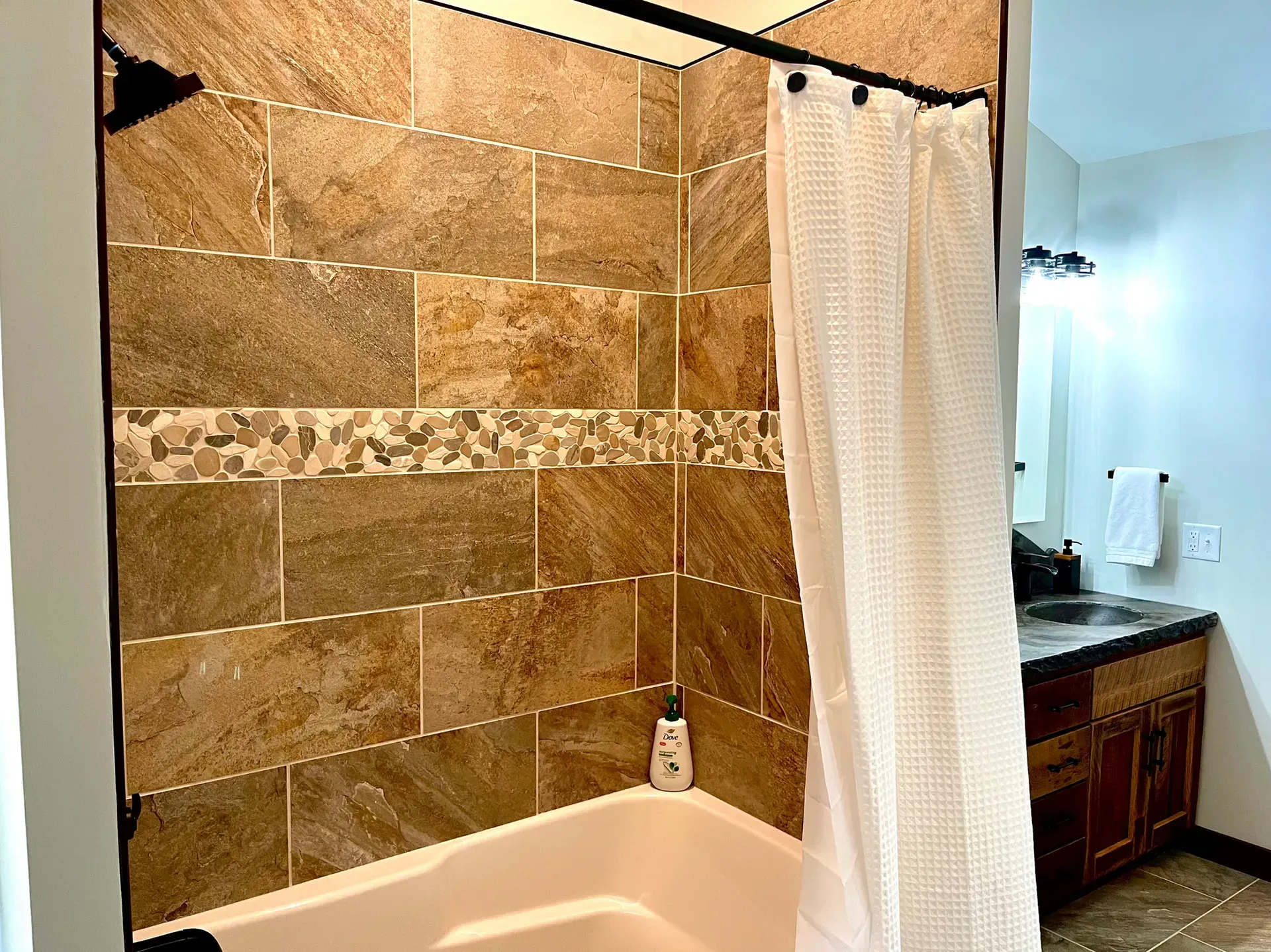 A bathroom with a bathtub and a shower curtain.