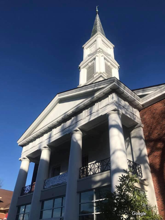 A church with a clock tower on top of it