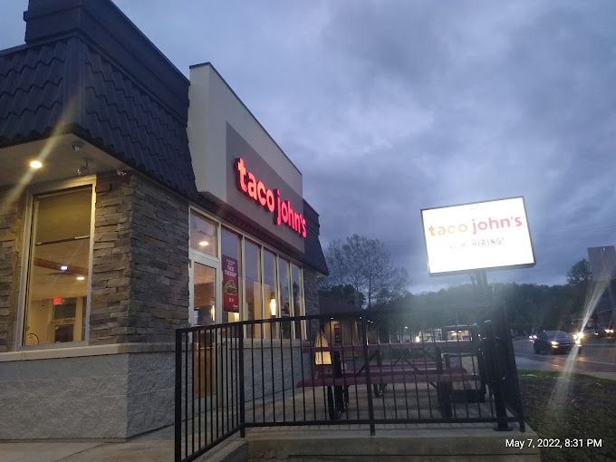 A taco john 's restaurant is lit up at night