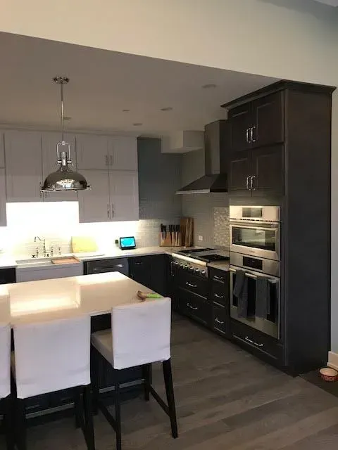 A kitchen with a table and chairs in it