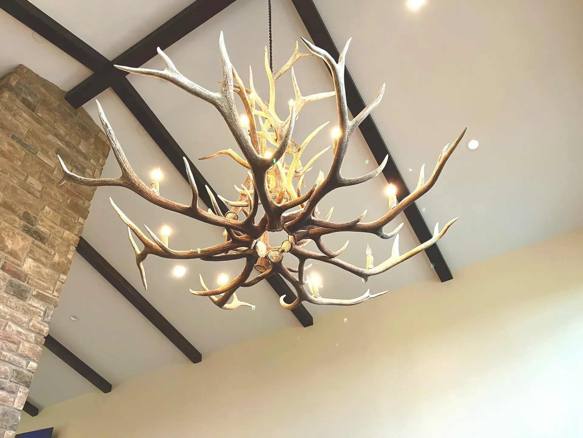 A chandelier made of antlers is hanging from the ceiling
