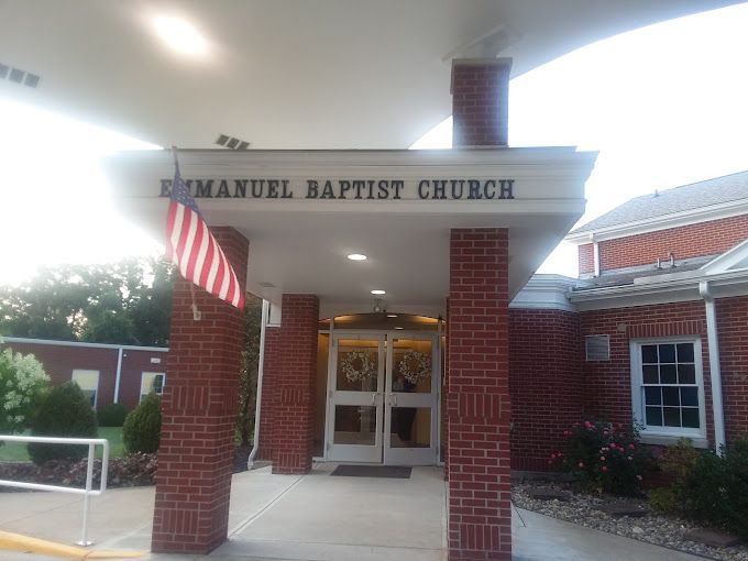 The entrance to the emanuel baptist church with an american flag