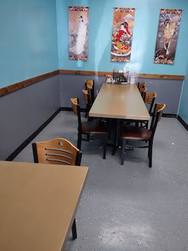 A dining room with a long table and chairs