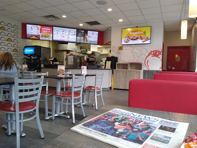 A restaurant with tables and chairs and a newspaper on the table