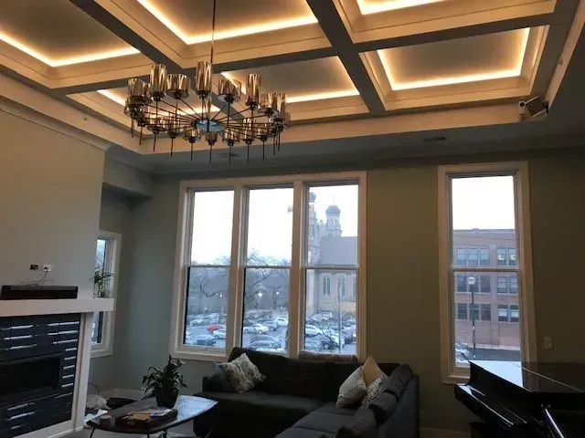 A living room with a chandelier hanging from the ceiling