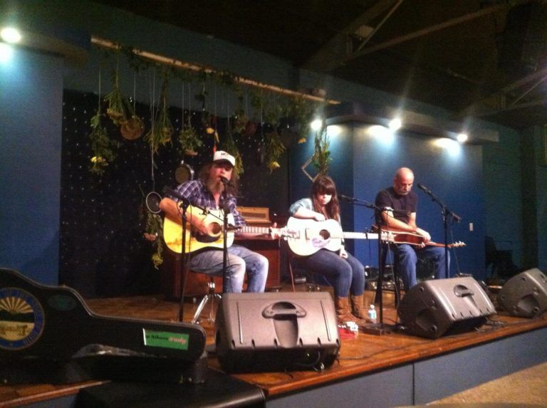 A group of people playing guitars on a stage