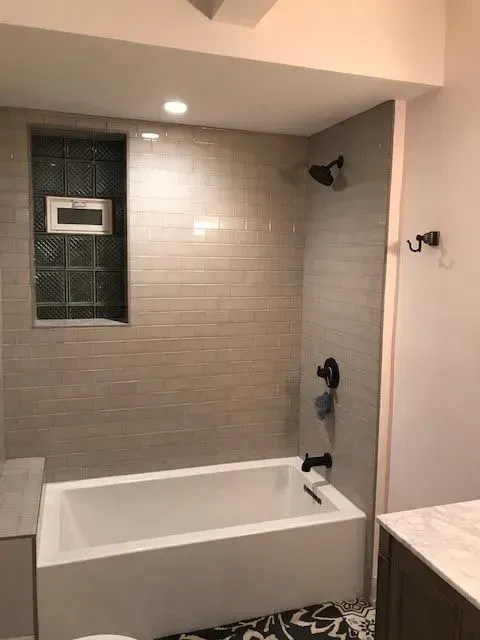 A bathroom with a bathtub and a shower.