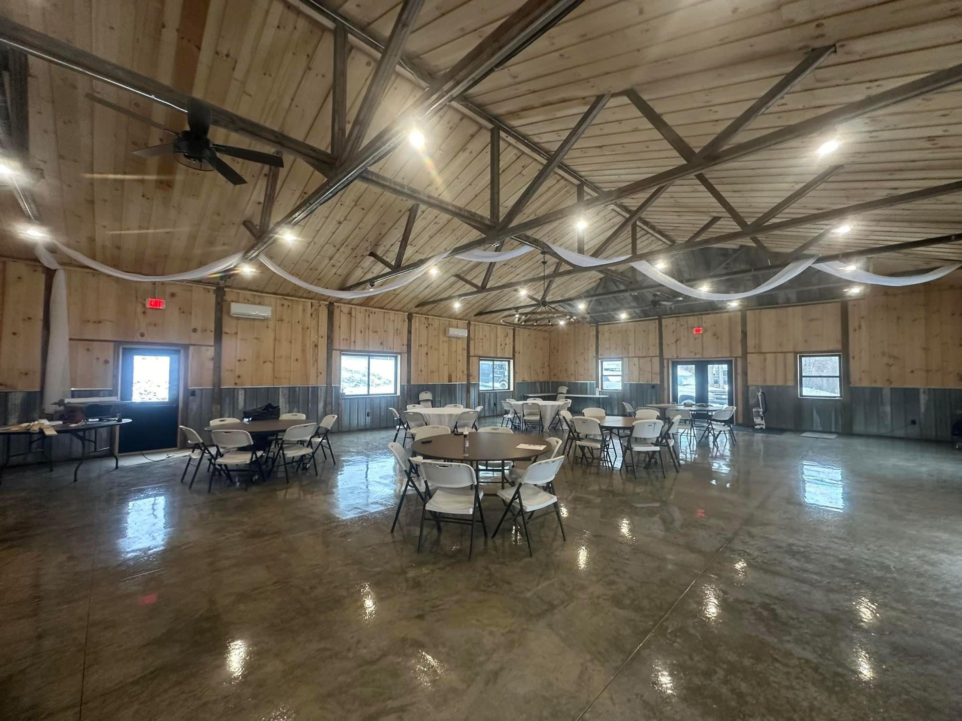 A large room with tables and chairs in it.