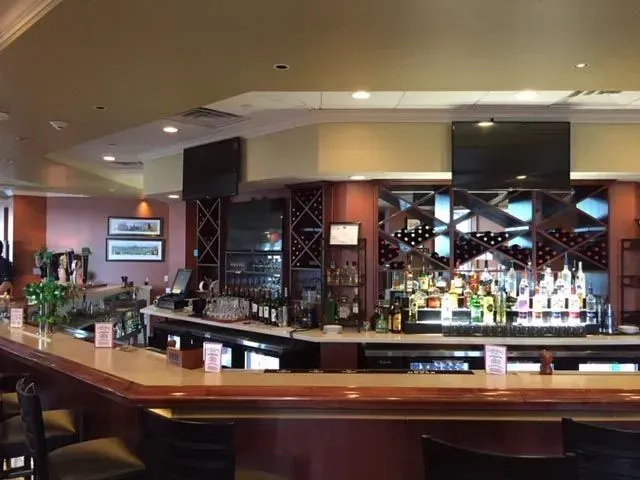 A bar with a lot of bottles of alcohol on it