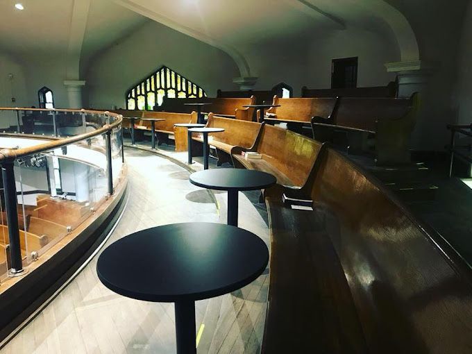A church with tables and benches in it