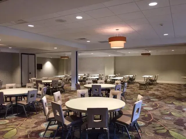 A large room with tables and chairs in it