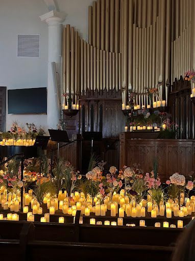 A church filled with lots of candles and flowers