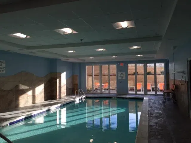 A large indoor swimming pool with lots of windows