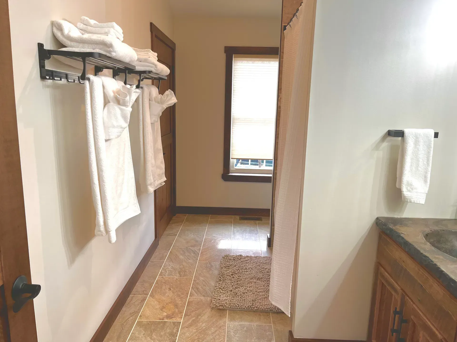 A bathroom with towels hanging on the wall and a sink