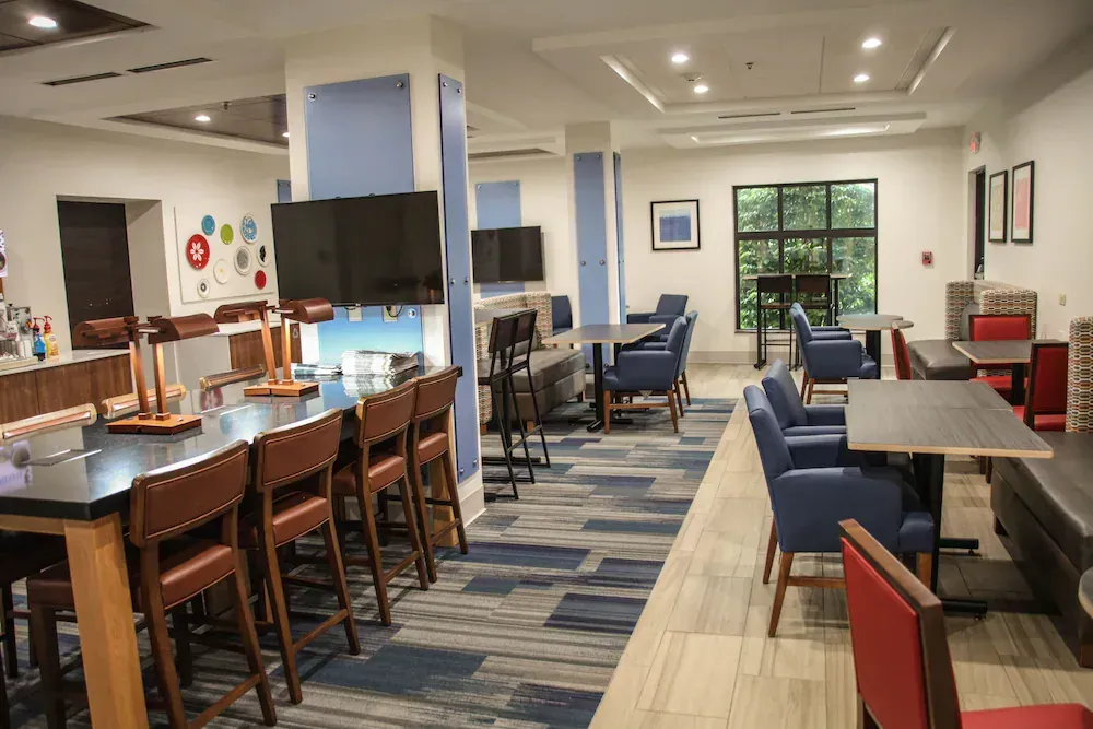 A large room with tables and chairs in it.