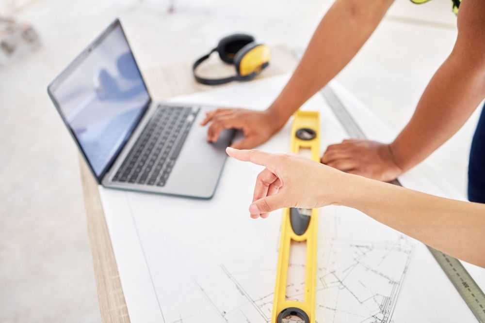 Architects are checking the details of the blueprint.