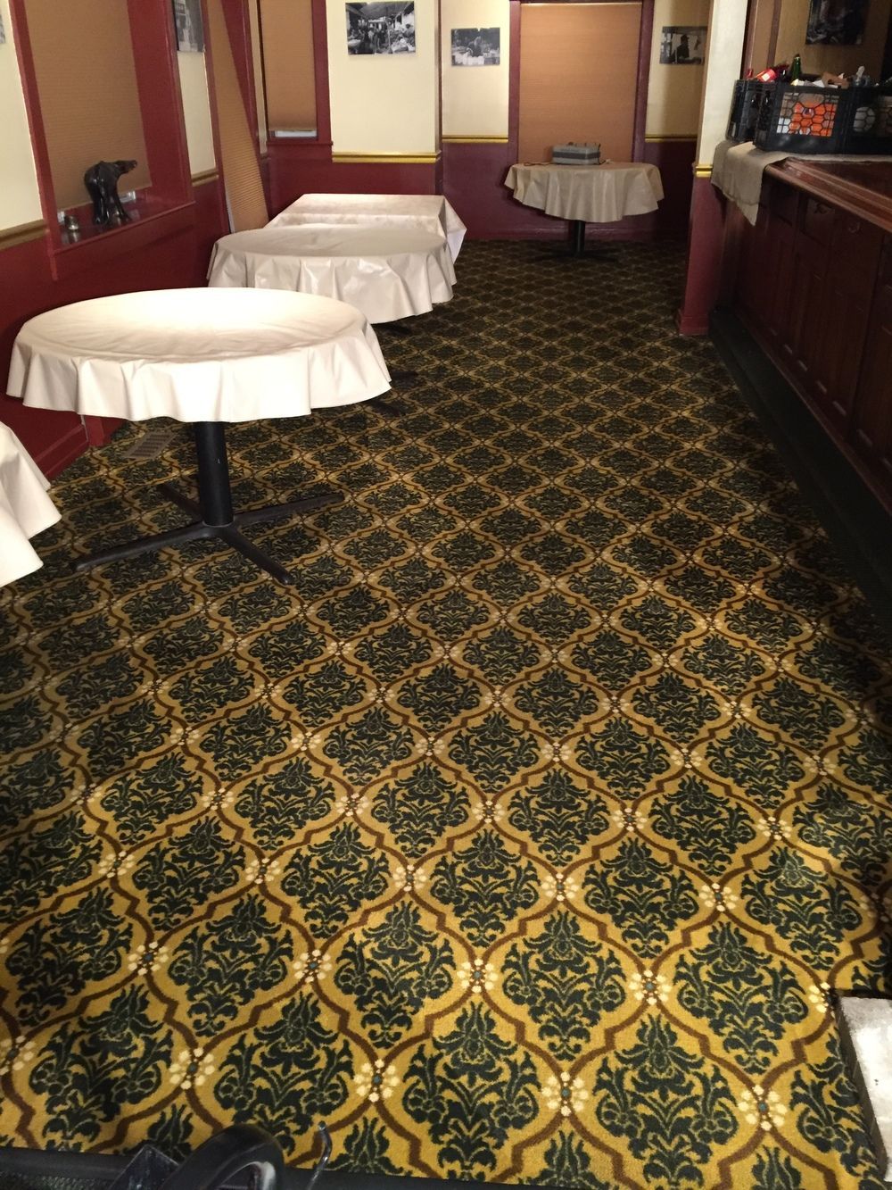 A room with tables and a patterned carpet
