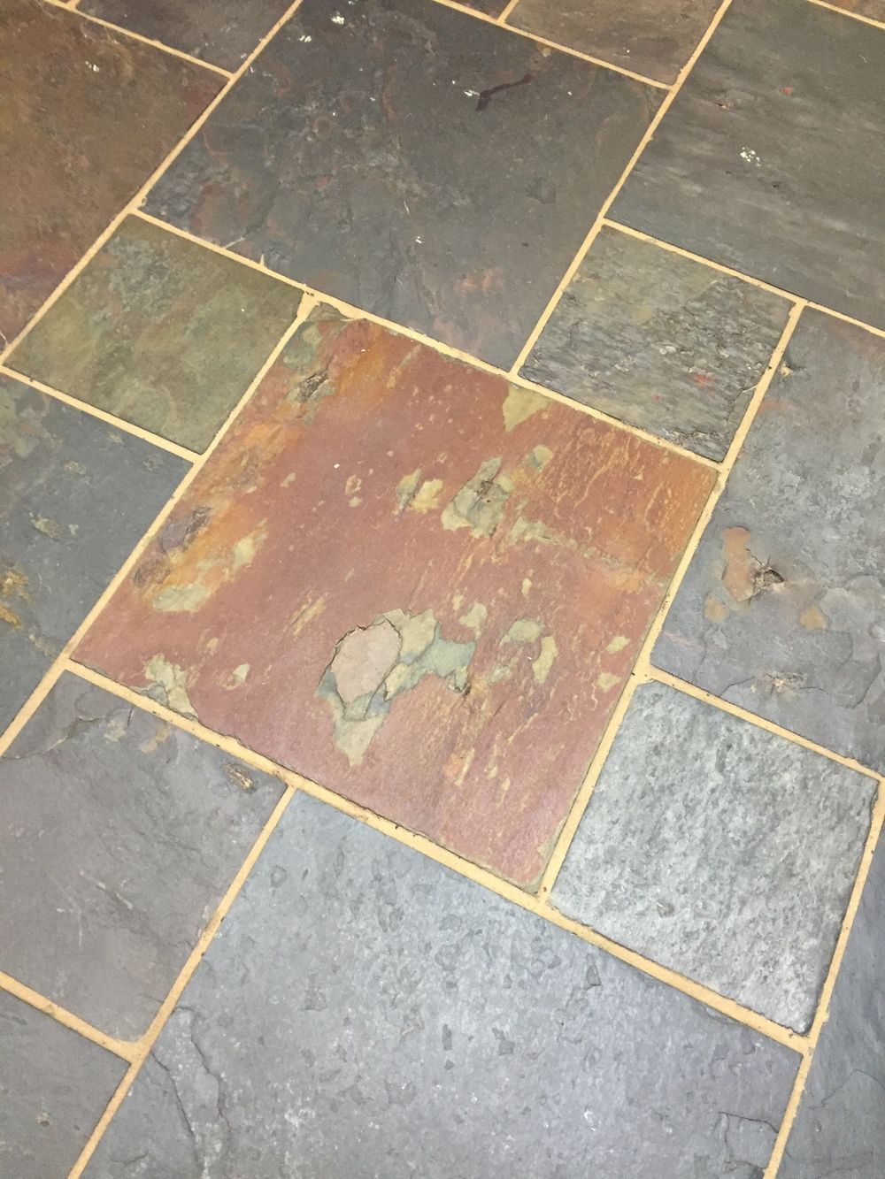 A tiled floor with a square in the middle