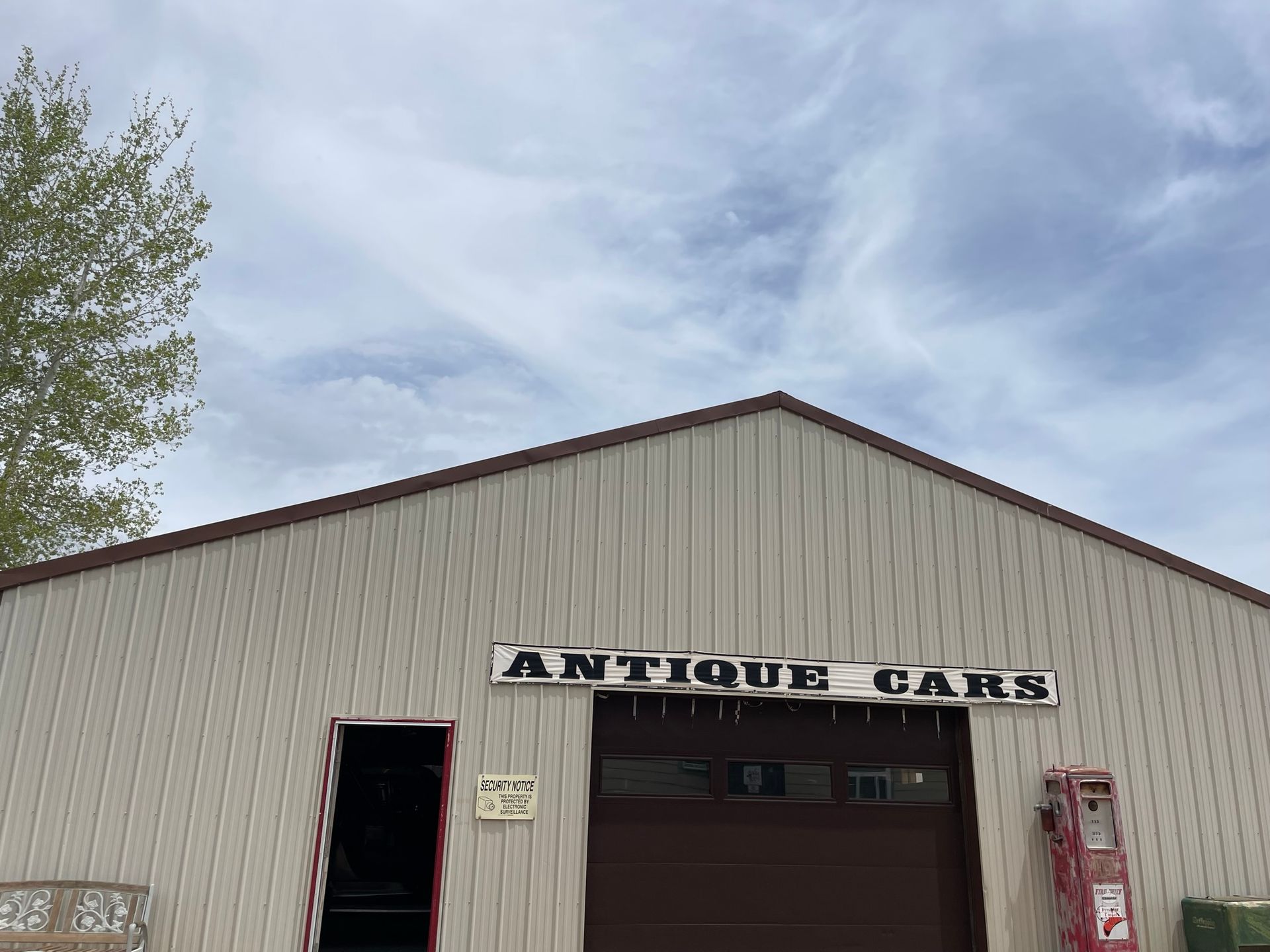 A large building with a sign that says antique cars on it.